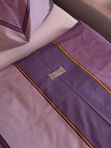 A bed or beds in a room at Pension Erlaa