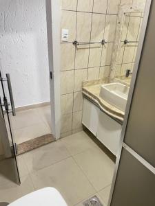 a bathroom with a sink and a shower stall at Residencial Vista da Serra in Diamantina +17 photos