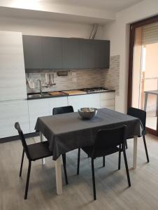 a table and chairs in a kitchen with a table and a bowl at Alloggio Turistico Roma in Rome