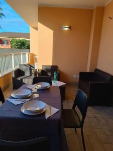 a dining room with a blue table with plates and chairs at Alloggio Turistico Roma in Rome