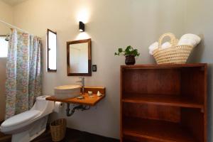 a bathroom with a sink and a toilet and a mirror at Villa Cielo de Diamantes in Tierra Blanca +53 photos