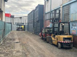 a forklift is parked next to a warehouse at Skladové priestory Bardejov in Bardejov