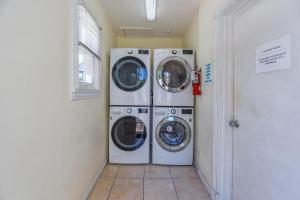 two washing machines are in a laundry room at Chagall's Corner in Key West