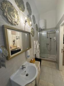 a bathroom with a sink and a shower at Birgu Lodge ground floor with Jacuzzi 0 in Birgu +15 photos