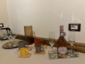 a bottle of wine sitting on a table with glasses at Re carlo suite & spa in Crotone