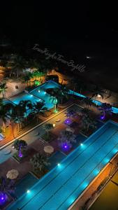 an overhead view of a swimming pool at night at Sea View & Pool View & WiFi & Netflix at Iman Kazoku TimurBay Ville Studio 2BDR in Kuantan +52 photos