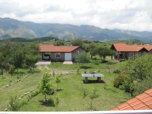 a garden with a bench in front of a house at Ayres Serranos in Merlo