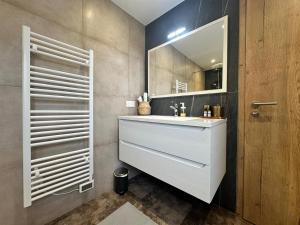 a bathroom with a white sink and a mirror at Les 7 Prunes - Demeure Alsacienne d'Exception in Zellwiller +54 photos