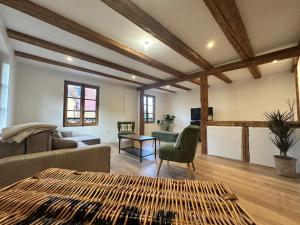 a living room with a couch and a table at Les 7 Prunes - Demeure Alsacienne d'Exception in Zellwiller