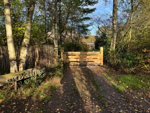 a dirt road with a fence and a bench at Erve Soebringe in Ansen