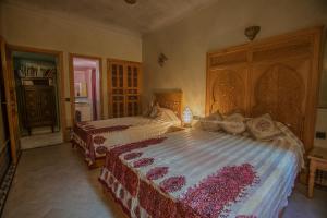 Postel nebo postele na pokoji v ubytování Riad Dar Ziryab