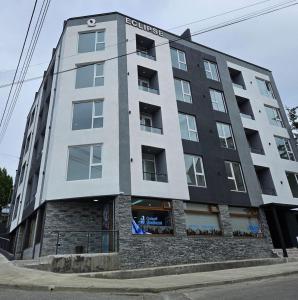 a tall building with the words serviced at Atardecer Sur Belgrano in Ushuaia
