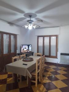 a dining room with a table and chairs and a ceiling at Casa Quinta Estilo Campo in Lobos