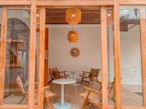 a room with chairs and a table and a table and a window at Little wild hostel khaosok in Khao Sok National Park +75 photos
