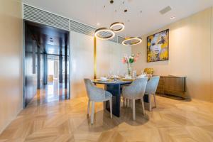 a dining room with a table and chairs at Superluxury Apartment in FIVE Palm, Pool & Beach Access in Dubai
