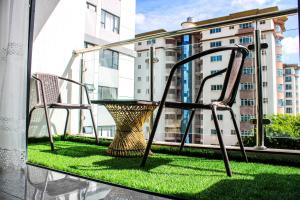 a table and chairs on a balcony with a window at Carolina Homes - Kilimani in Nairobi