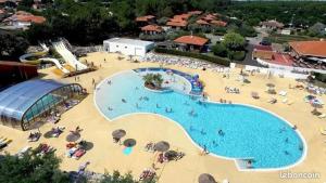 a large swimming pool with people in a resort at MH Camping la plage - MarieVa in Mimizan-Plage