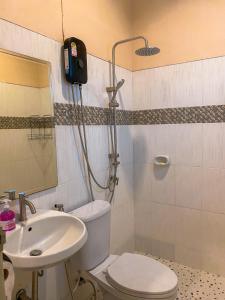 a bathroom with a toilet and a sink at Little wild hostel khaosok in Khao Sok National Park