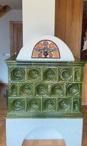 a green dresser with a floral pattern on it at Chalet Genziana in Cavalese