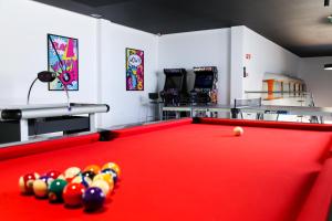 a billiard room with a red pool table at RIDE Surf Resort & Spa Peniche in Peniche