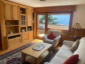 a living room with a couch and a table at Chalet Genziana in Cavalese