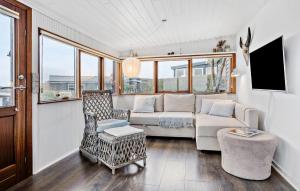 een woonkamer met een bank en een stoel bij 3 Bedroom Cozy Home In Juelsminde in Sønderby