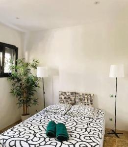 a bedroom with a bed with green shoes on it at Maison splendide avec piscine in Ribérac +25 photos