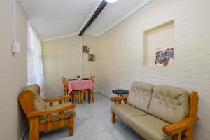 a living room with a couch and chairs and a table at Resthaven in Margate