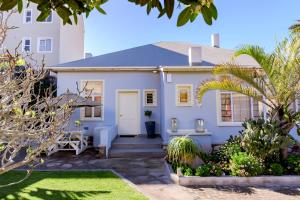 a white house with palm trees in front of it at Villa Margherita in Swakopmund