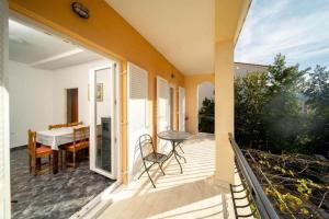a balcony with a table and chairs on a house at Apartments BePa in Lopar