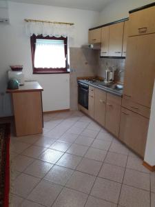 a kitchen with a sink and a stove top oven at Apartment Ani in Supetarska Draga