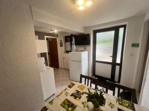 a kitchen with a table and a dining room at Apartment Ani in Supetarska Draga