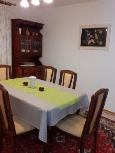 a dining room table with a green table cloth on it at Apartment Ani in Supetarska Draga