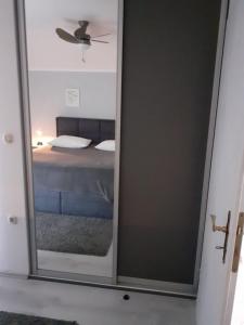 a mirror in a room with a bed and a ceiling at Apartment Ani in Supetarska Draga +34 photos