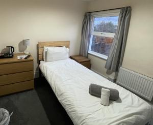 a bedroom with a bed and a window at Admiral Blake Guesthouse in Bridgwater
