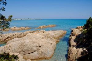 a group of rocks in the water near the ocean at Residence with swimming-pool in Sos Alinos in Orosei