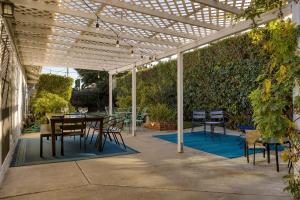 a patio with a table and chairs under a pergola at Goleta Getaway by AvantStay Private Backyard 1.5mi to the Beach in Santa Barbara