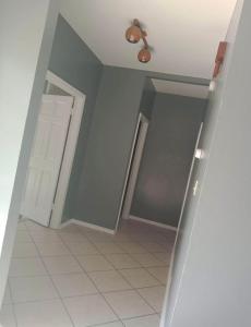 a hallway with a door and a ceiling fan at Blue Beauty located by LSU in Baton Rouge