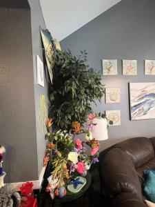 a living room with a plant on the wall at Blue Beauty located by LSU in Baton Rouge