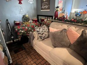 a living room with a couch and christmas decorations at Blue Beauty located by LSU in Baton Rouge +1 photo