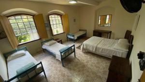 Postel nebo postele na pokoji v ubytování Brumas Ouro Preto Hostel e Pousada
