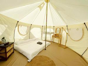 a bedroom with a tent with a bed and a chair at Damboung Bungalow in Kampot +36 photos