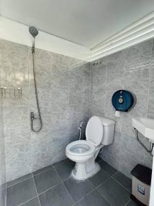 a bathroom with a toilet and a shower at Damboung Bungalow in Kampot