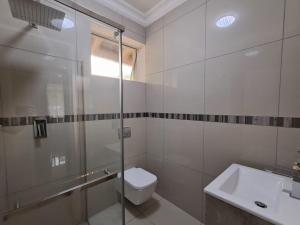 a bathroom with a shower and a toilet and a sink at 188 On Springs Road in Brakpan +29 photos