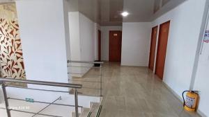 a hallway of a building with stairs and doors at HOTEl LONDON NL in Fuente de Oro