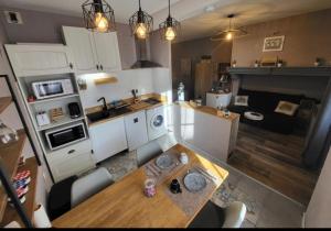 an overhead view of a kitchen with a dining table and a kitchen at gardenhill in Argelès-Gazost
