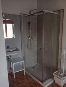 a glass shower in a bathroom with a sink at La Herrería de Somo in Somo +21 photos