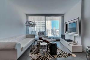 a living room with a couch and a zebra rug at Apartamento en Punta del Este Uruguay in Punta del Este
