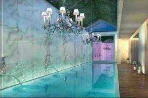a room with a swimming pool with a chandelier at Apartamento en Punta del Este Uruguay in Punta del Este