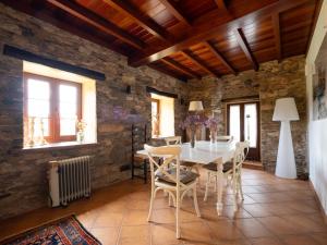 a dining room with a white table and chairs at Casa Balteira da Terra, Cedeira in Cedeira